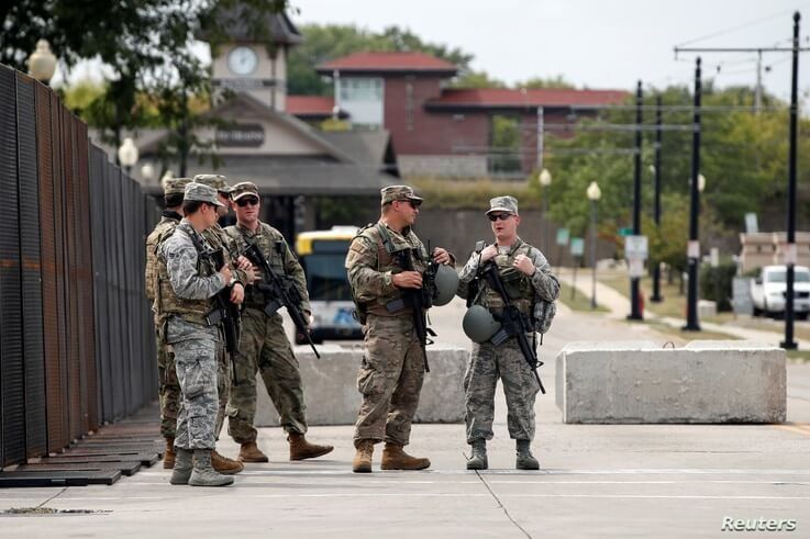 Members of the Wisconsin National Guard stand outside Kenosha County Public Safety Building.