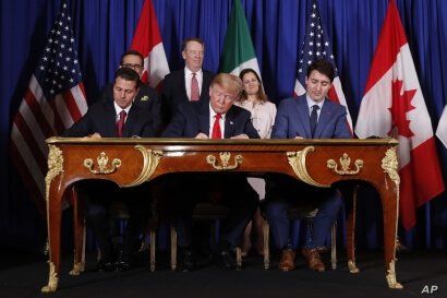 President Donald Trump, Canada's Prime Minister Justin Trudeau, right, and Mexico's then-President Enrique Pena Nieto, left, participate in the USMCA signing ceremony, Nov. 30, 2018, in Buenos Aires, Argentina.