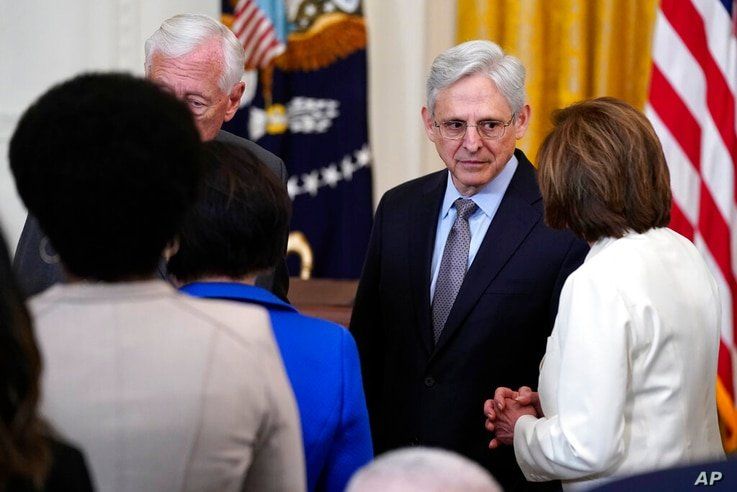 House Speaker Nancy Pelosi of Calif., talks with Attorney General Merrick Garland before the signing the COVID-19 Hate Crimes…