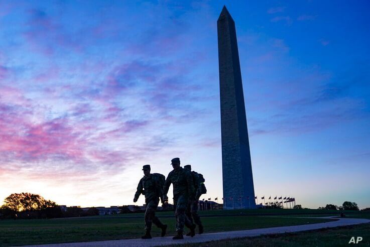 United States National Guard members walk towards the White House from the Washington Monument on Election Day, Tuesday, Nov. 3…