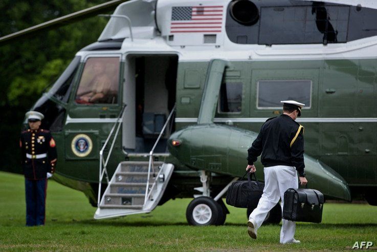 A military aid carries a suitcase with nuclear codes while accompanying US President Barack Obama to Marine One of the South…