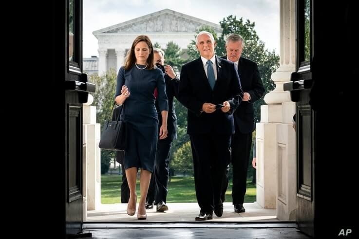 Judge Amy Coney Barrett, President Donald Trump's nominee to the Supreme Court and Vice President Mike Pence arrive at the…