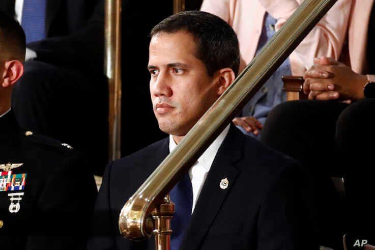 Venezuelan opposition leader Juan Guaido listens as President Donald Trump delivers his State of the Union address to a joint…