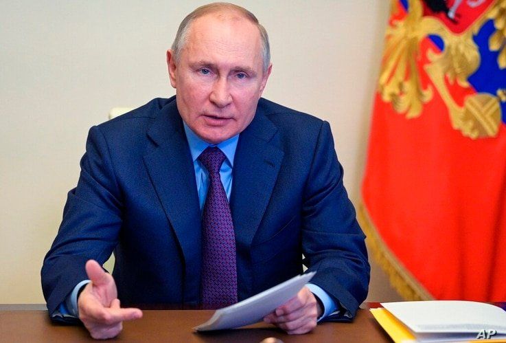 Russian President Vladimir Putin gestures during a meeting via video conference at the Novo-Ogaryovo residence outside Moscow,…