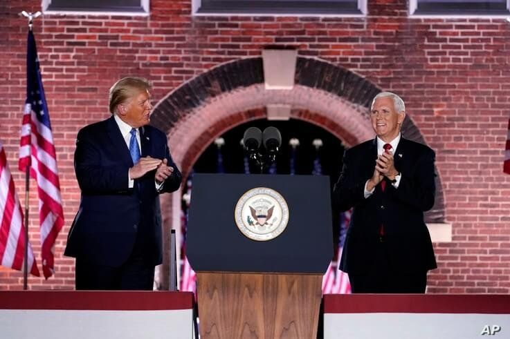 Vice President Mike Pence stands on stage with President Donald Trump after Pence spoke on the third day of the Republican…