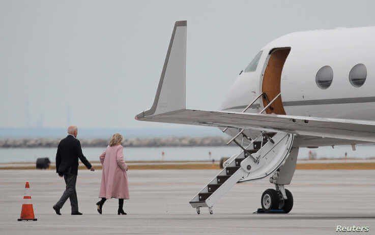 Democratic U.S. presidential candidate and former Vice President Joe Biden walks across the airport tarmac to his campaign…