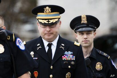Army Lieutenant Colonel Alexander Vindman, a military officer at the National Security Council, center, arrives on Capitol Hill in Washington, to testify as part of the U.S. House of Representatives impeachment inquiry into President Donald Trump.