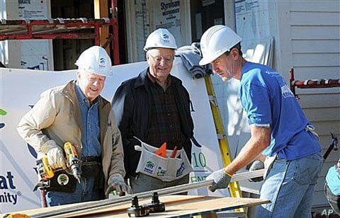 Former President Jimmy Carter, left, former Vice-President Walter Mondale, center, and Minneapolis Mayor R.T. Rybak work together with volunteers with Habitat For Humanity to repair an old home in Minneapolis, Minn., 6 Oct 2010