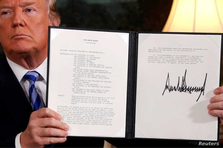 U.S. President Donald Trump holds up a proclamation declaring his intention to withdraw from the JCPOA Iran nuclear agreement after signing it in the Diplomatic Room at the White House in Washington, May 8, 2018. 