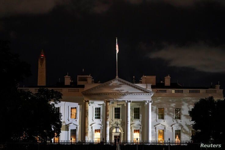 The White House is lit before dawn after U.S. President Donald Trump announced that he and U.S. first lady Melania Trump have…