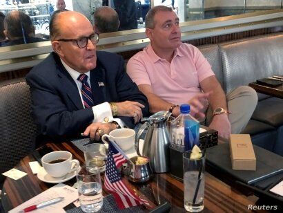 FILE PHOTO: U.S. President Trump's personal lawyer Rudy Giuliani has coffee with Ukrainian-American businessman Lev Parnas at…