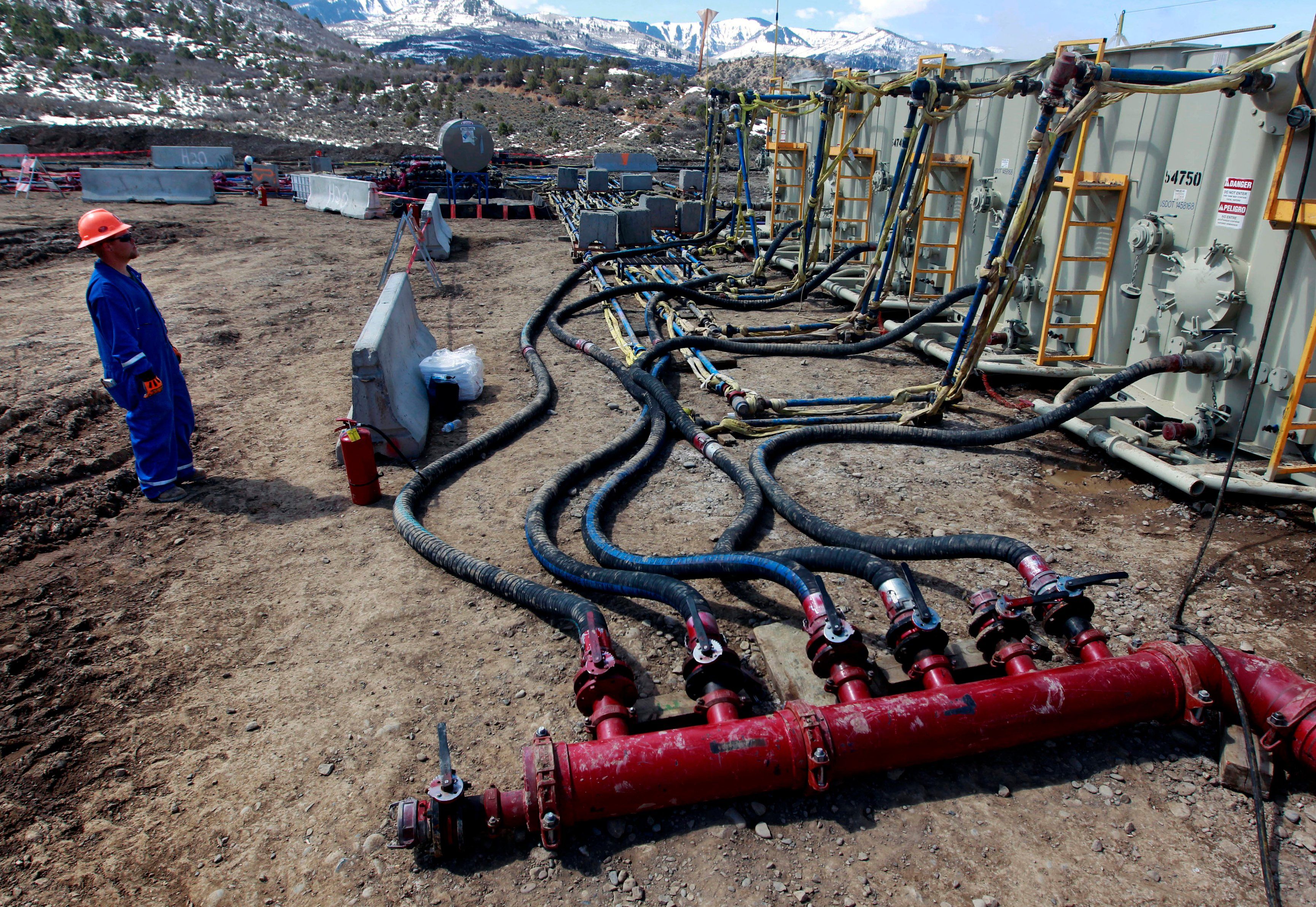 FILE - A worker helps monitor water pumping pressure and temperature at an oil and natural gas extraction site in Colorado, March 29, 2013.A Trump administration national security official has sought help from advisers to a think tank that disavows climate change to challenge widely accepted scientific findings on global warming, according to his emails. 