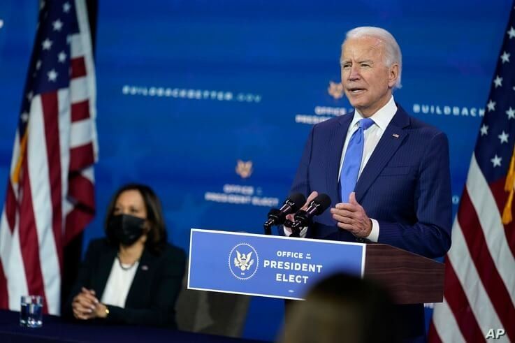 President-elect Joe Biden speaks as Vice President-elect Kamala Harris listens at left, during an event to introduce their…