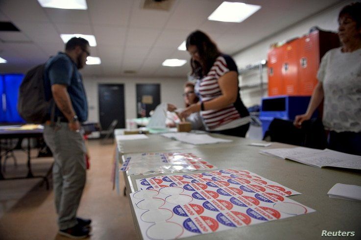 Voters sign in to cast their ballot at a polling place in Philadelphia, Pennsylvania, April 26, 2016.
